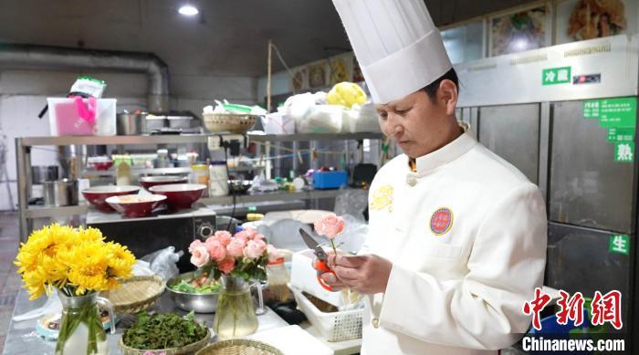 3月12日，云南昆明，烹饪大师陈生合正准备制作鲜花宴。白玲 摄